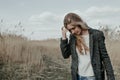 Young european woman walking on country road through bulrush Royalty Free Stock Photo