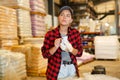 Female warehouse worker using smartphone to check quantity of goods Royalty Free Stock Photo