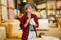 Female warehouse worker using smartphone to check quantity of goods Royalty Free Stock Photo