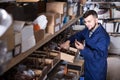 Worker checking small details for sanitary engineering in workshop Royalty Free Stock Photo