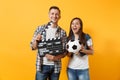 Young excited couple woman man football fans cheer up support team with soccer ball, film making clapperboard isolated Royalty Free Stock Photo