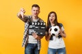 Young excited couple woman man football fans cheer up support team with soccer ball, film making clapperboard isolated Royalty Free Stock Photo