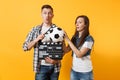 Young excited couple woman man football fans cheer up support team with soccer ball, film making clapperboard isolated Royalty Free Stock Photo