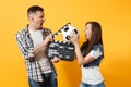 Young excited couple woman man football fans cheer up support team with soccer ball, film making clapperboard isolated Royalty Free Stock Photo