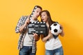 Young excited couple woman man football fans cheer up support team with soccer ball, film making clapperboard isolated Royalty Free Stock Photo