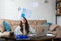 Young excited fun entrepreneur woman throwing papers celebrating business success at home office. Student girl throwing utility Royalty Free Stock Photo