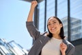 Young excited happy Asian business woman celebrating success in city. Royalty Free Stock Photo