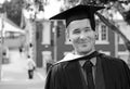 Young excited nervous man uni graduation day in cap