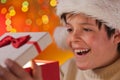 Young excited teenager boy opening his christmas present Royalty Free Stock Photo