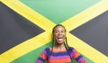 Young excited woman against Jamaican flag