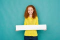 Young excited woman holding blank white banner Royalty Free Stock Photo