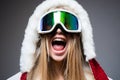 Young excited woman in ski goggles. Close up winter portrait of young amazing girl with snow goggles. Royalty Free Stock Photo