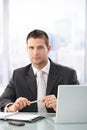 Young executive sitting in bright office