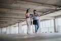 Young executives discuss business expansion plans while inspecting a construction site in the urban center Royalty Free Stock Photo