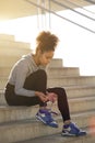 Young exercise woman tying her shoelaces