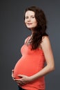 Young expecting mother with long dark hair.