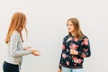 Young expressive girls having active conversation Royalty Free Stock Photo