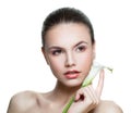 Young face. Spa woman with healthy skin and lily flower isolated on white background. Facial treatment, cosmetology and skincare Royalty Free Stock Photo