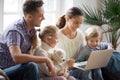 Young family with adopted children using laptop together at home Royalty Free Stock Photo