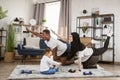 Young family african man and muslim arabic woman practising yoga stretching workout at home Royalty Free Stock Photo