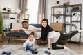 Young family african man and muslim arabic woman practising yoga stretching workout at home Royalty Free Stock Photo