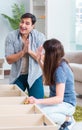 Young family assembling furniture at new house