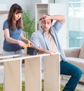 Young family assembling furniture at new house