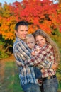 Young family in autumn forest