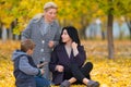 Young family in an autumn park. Royalty Free Stock Photo