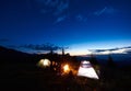 Family hikers having a rest at night camping in mountains Royalty Free Stock Photo