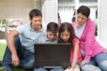 Young family in backyard using laptop Royalty Free Stock Photo