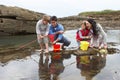 Young family at beach collecting shells