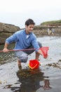 Young family at beach collecting shells Royalty Free Stock Photo