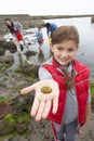 Young family at beach collecting shells