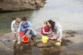 Young family at beach collecting shells Royalty Free Stock Photo