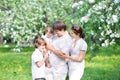 Young family in a beautiful apple tree garden Royalty Free Stock Photo