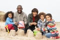 Young Family Building Sandcastle On Beach Holiday Royalty Free Stock Photo