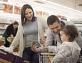 Young family buying in supermarket Royalty Free Stock Photo