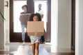 Young family carry boxes moving to new home Royalty Free Stock Photo