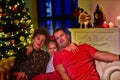 Young family celebrating Christmas at home.Happy young family enjoying their holiday time together. Royalty Free Stock Photo
