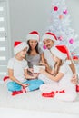 Young family celebrating Christmas at home.Happy young family enjoying their holiday time together Royalty Free Stock Photo