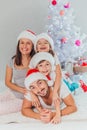 Young family celebrating Christmas at home.Happy young family enjoying their holiday time together Royalty Free Stock Photo