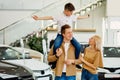 Young family with child happy after getting keys from their new car Royalty Free Stock Photo