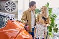 Young family with child happy after getting keys from their new car Royalty Free Stock Photo