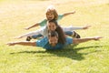 Young family with child having fun in nature. Fly concept, little boy is sitting pickaback while imitating the flight.