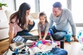 Young family with a child packing for holiday. Royalty Free Stock Photo