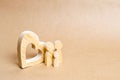 A young family with a child is standing near a wooden heart. Love and loyalty, a strong young family. Family relationships. Royalty Free Stock Photo