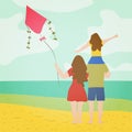 A young family with a child watching the sea on the beach with a kite in their hands. Summer season holiday vacation concept. Royalty Free Stock Photo