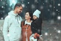 Young family with children are walking in the winter forest. Winter walk of parents with children. Walking on holiday weekend in Royalty Free Stock Photo