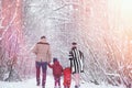 Young family with children are walking in the winter park. Winte Royalty Free Stock Photo